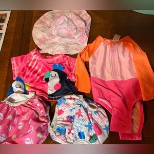 Baby Swim Lot. 2 swim diapers. 1 reversible hat. 1 piece suit. 1 rash guard